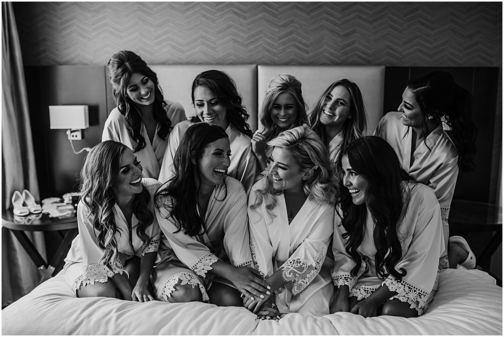 bride and bridesmaids matching robes candid