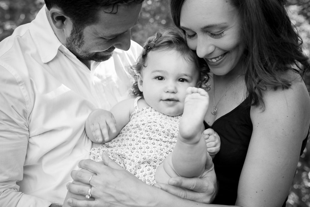 Parents holding a sweet baby in a black and white photo