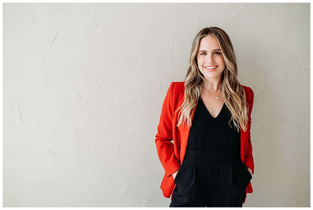 woman in red blazer smiling