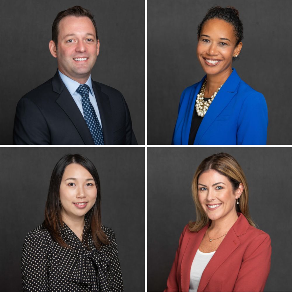 Headshots of corporate business people on dark grey backdrop.