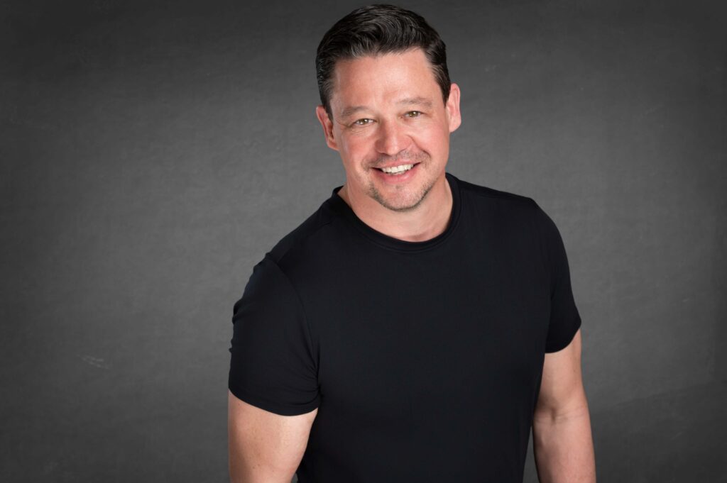 Headshot of man in black t-shirt