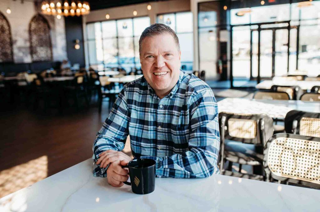 Chicago Dating Profile Photographer Photo of a Man in Coffee Shop smiling at camera