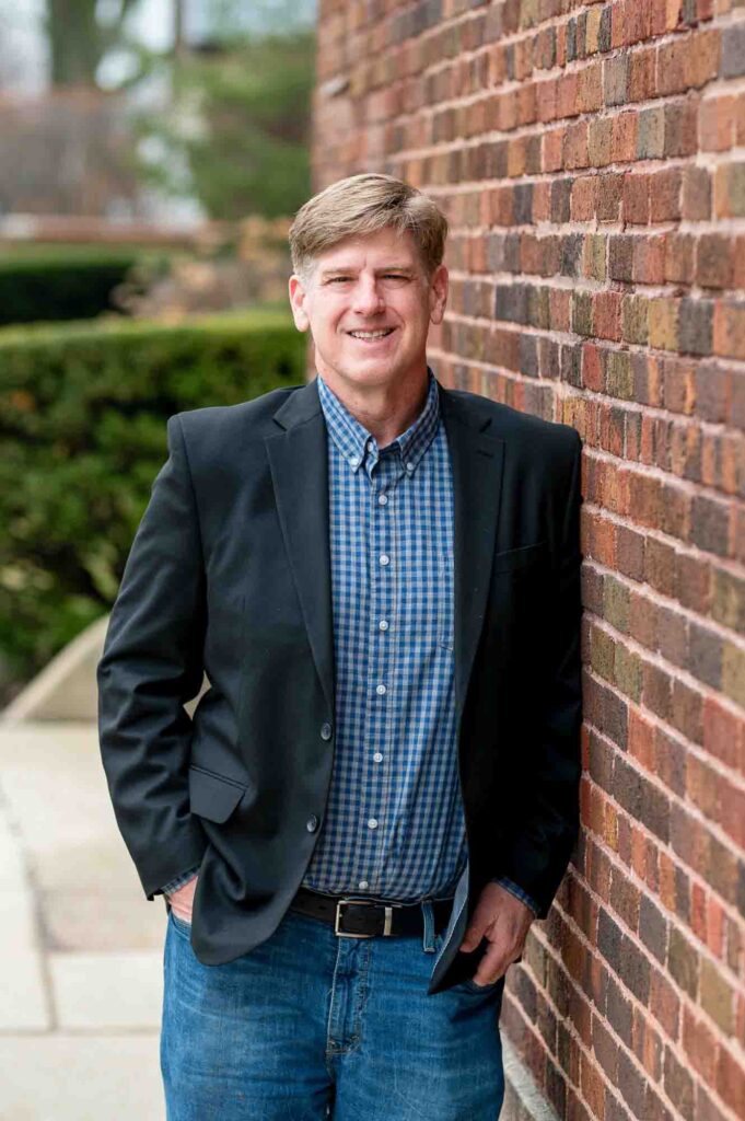 Chicago Dating Profile Photographer Photo of a Professional man leaning against brick wall