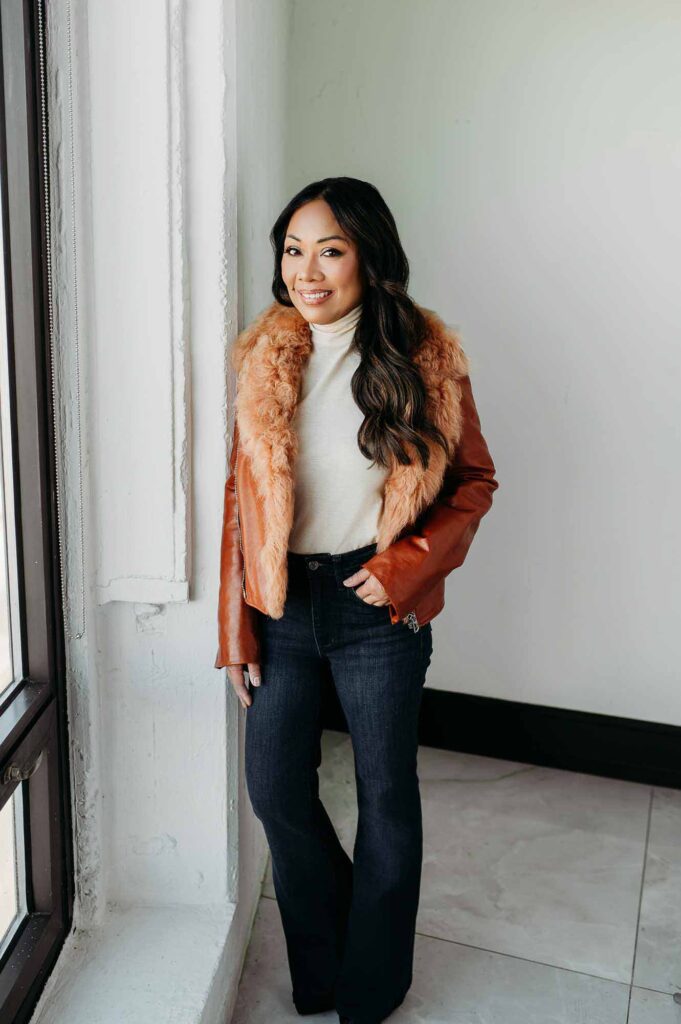 Chicago Dating Profile Photographer Photo of a Woman standing next to window with brown jacket on