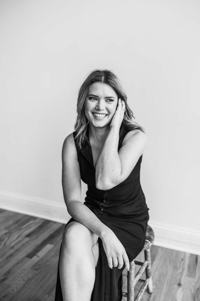 Black and White photo of woman smiling away from camera